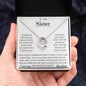 a white gold lucky in love necklace up close in models hand