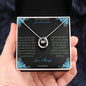 Lucky In Love Necklace with a white gold charm on a to granddaughter from grandpa greeting card in a models hand