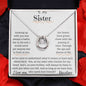 a white gold lucky in love necklace up close with red rose petals