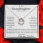 A white gold lucky in love necklace up close in a two-tone box