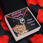 lucky in love necklace in a soft box angled to the right