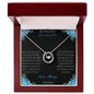 Lucky In Love Necklace with a white gold charm on a to granddaughter from grandpa greeting card in a mahogany box