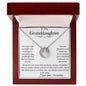 A white gold lucky in love necklace up close in a mahogany box