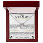 a lucky in love necklace up close in a mahogany box.