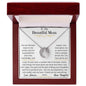 a lucky in love necklace up close in a mahogany box