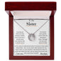 a white gold lucky in love necklace up close in a mahogany box
