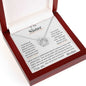 a white gold lucky in love necklace up close in a mahogany box angle left