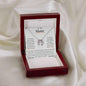 a white gold lucky in love necklace in a mahogany box on a white cloth