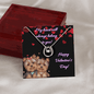 lucky in love necklace on a greeting card leaning on a closed mahogany box up close