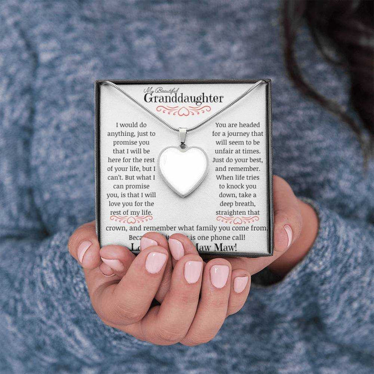 a polished stainless-steel photo upload personalized heart necklace up close in models hands