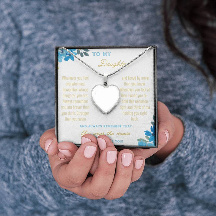 a polished stainless-steel photo upload personalized heart pendant necklace in a models hands
