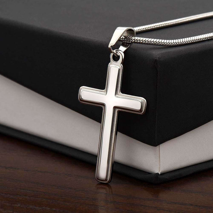 personalized cross on snake chain necklace on top of a soft box