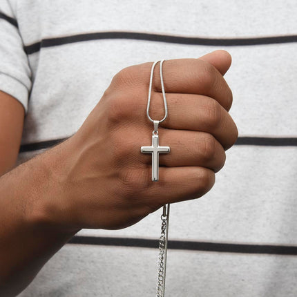 personalized cross snake chain necklace held in the hand of a model