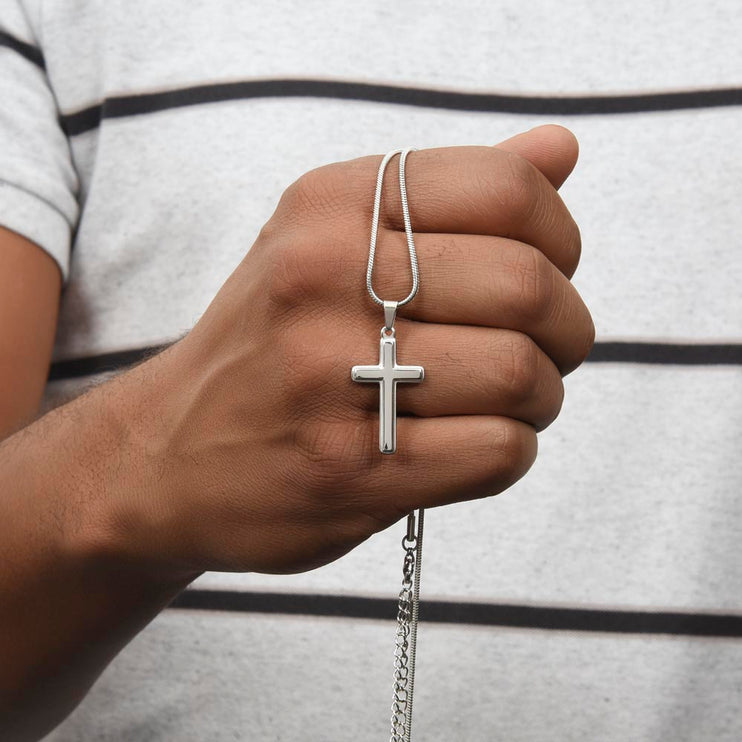 personalized cross snake chain necklace held in the hand of a model