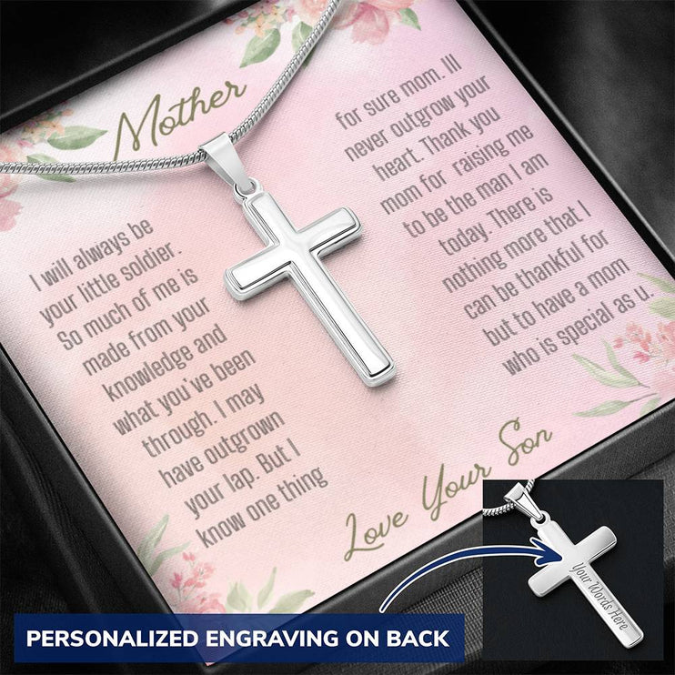A personalized cross necklace in a two-tone box angled to the left.