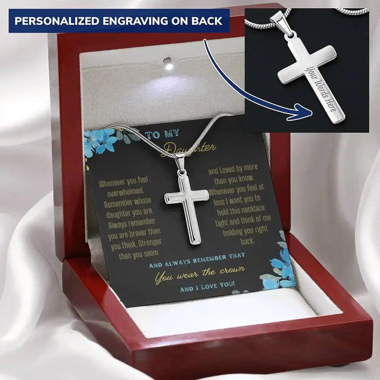 a personalized cross necklace in a mahogany box angled left.
