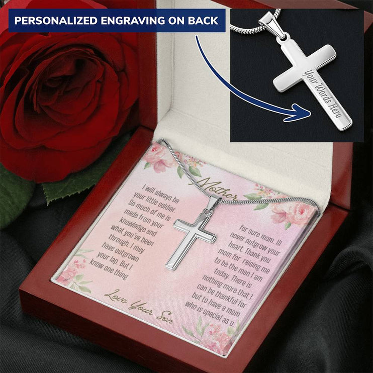 A personalized cross necklace in a mahogany box showing engraving.