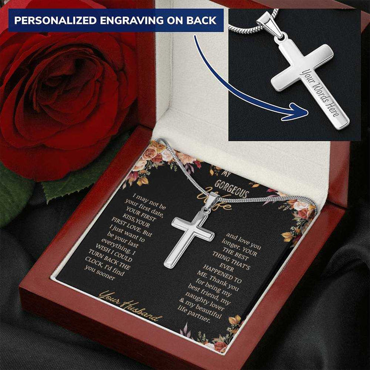 A personalized cross necklace oA personalized cross necklace on a to gorgeous wife greeting card in a mahogany box on a white cloth angled to the right.n a to gorgeous wife greeting card in a mahogany box on a white cloth angled to the right with a red rose.