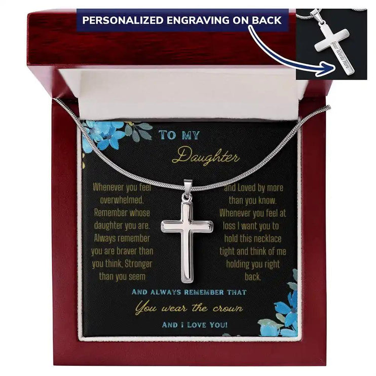 a personalized cross necklace up close in a mahogany box.