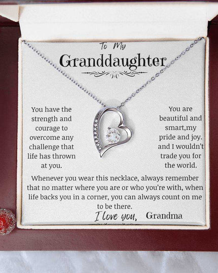 a white gold forever love necklace up close in a mahogany box.