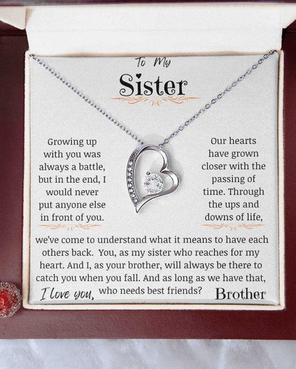 a white gold forever love necklace in a mahogany box up close.