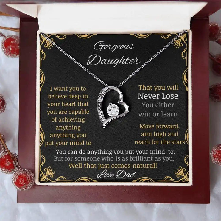 Forever Love Necklace with a white gold charm in a mahogany box with a to daughter from dad greeting card angle close up on a table 