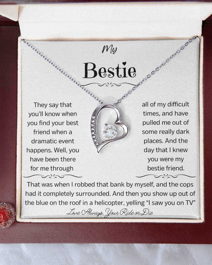 a white gold forever love necklace up close in a mahogany box