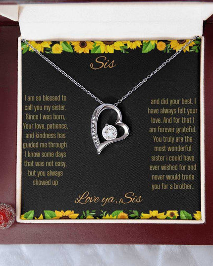 Forever Love Necklace with a white gold charm on a To Sis from Sis greeting card up close in a mahogany box