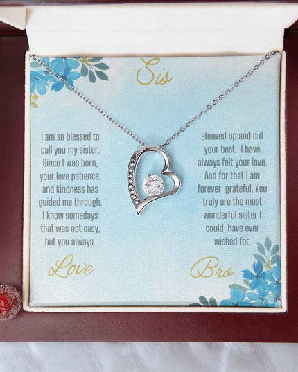 Forever Love Necklace with a white gold variant on a to sis from bro greeting card close up view in a mahogany box.