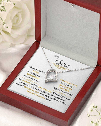 white gold forever love necklace in a luxury box angled left with flowers