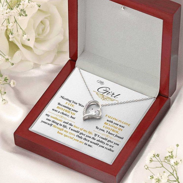 white gold forever love necklace in a luxury box angled left with flowers