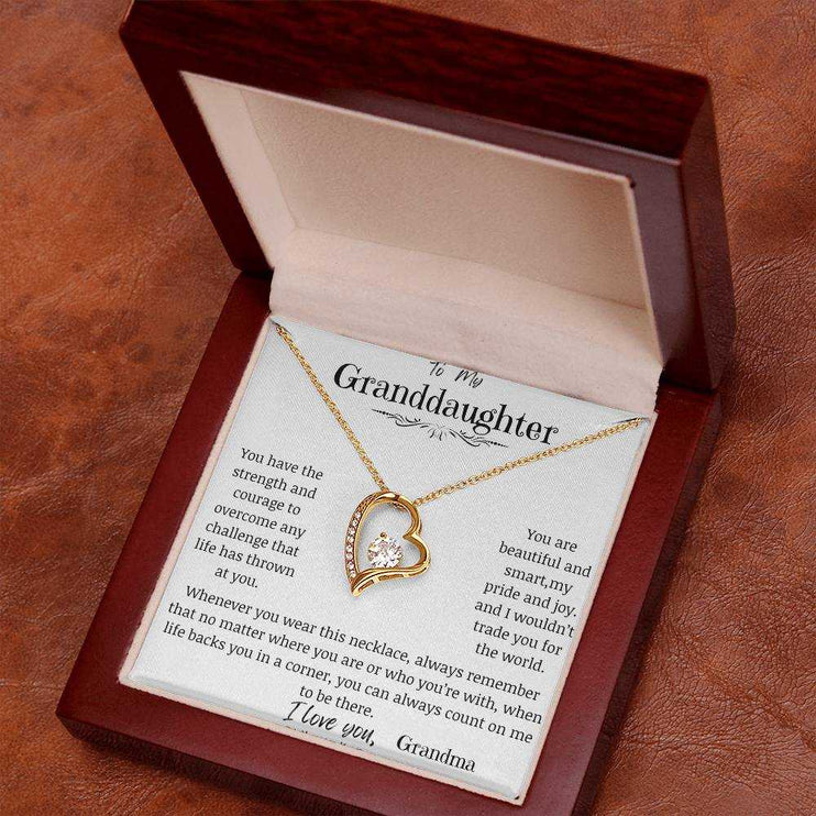 a yellow gold forever love necklace in a mahogany box.