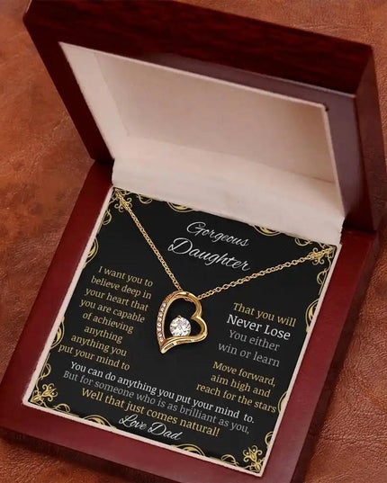 Forever Love Necklace in a mahogany box with a yellow gold pendant angled away and to the left