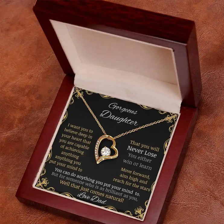 Forever Love Necklace in a mahogany box with a yellow gold pendant angled away and to the left
