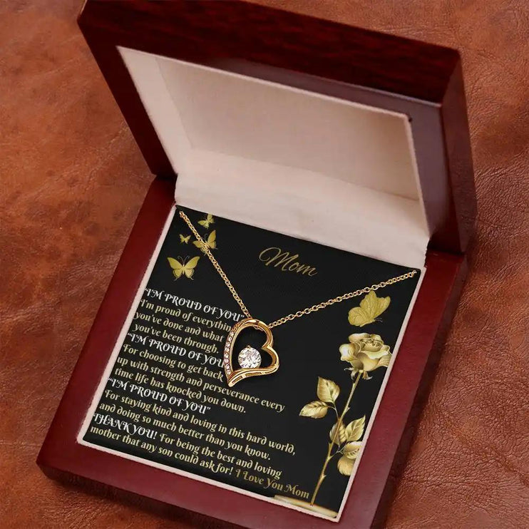 yellow gold forever love necklace in mahogany box angled right