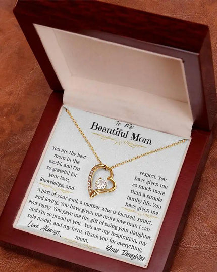 a yellow gold forever love necklace up close in mahogany box on rustic table