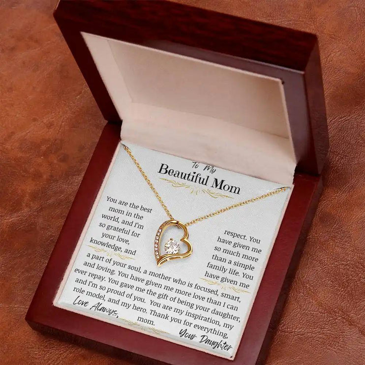 a yellow gold forever love necklace up close in mahogany box on rustic table
