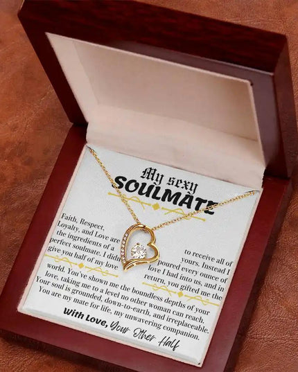 a yellow gold forever love necklace in a mahogany box
