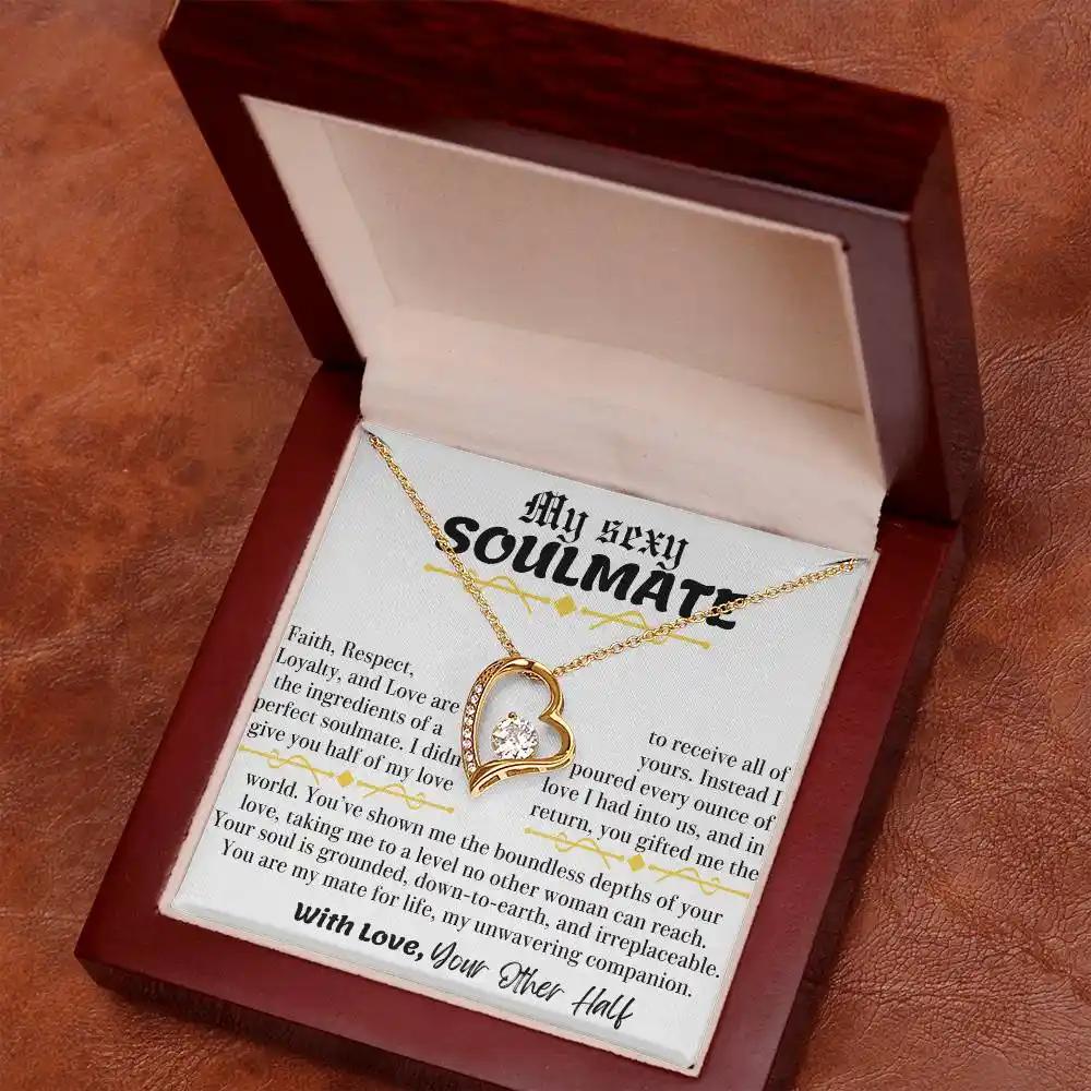 a yellow gold forever love necklace in a mahogany box