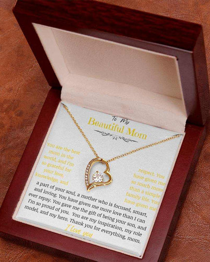 A yellow gold forever love necklace in a mahogany box angled to right