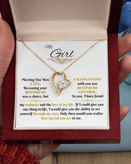 gold forever love necklace in a luxury box in model's hand