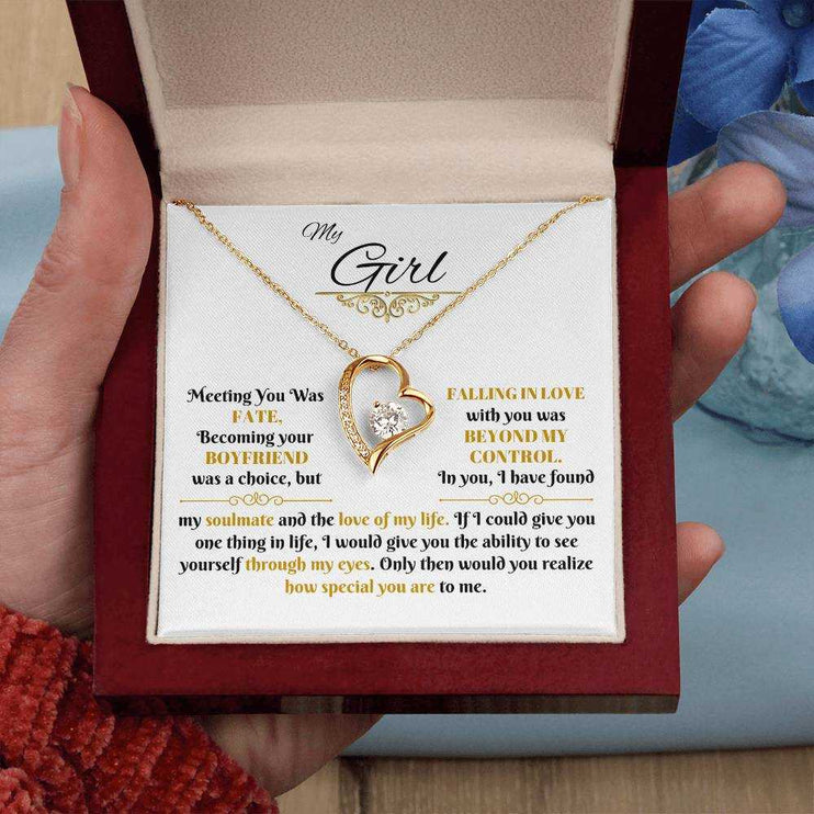 gold forever love necklace in a luxury box in model's hand