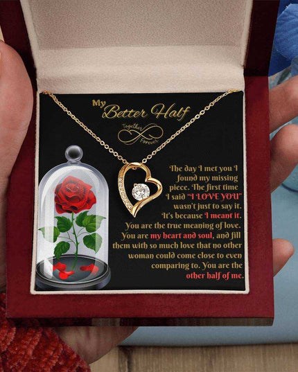 yellow gold forever love necklace in a luxury box in model's hand