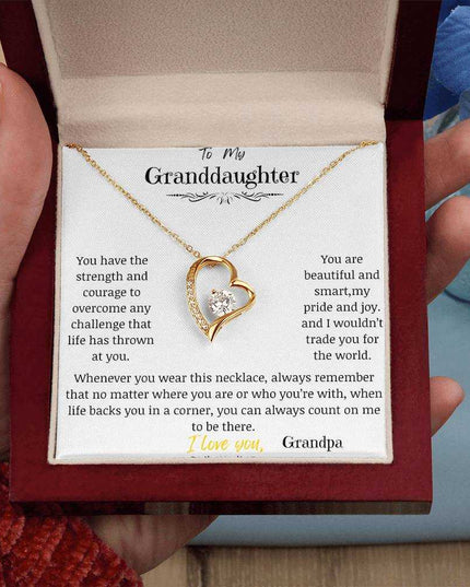 a yellow gold forever love necklace in a mahogany box