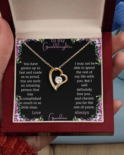 Forever Love Necklace with a yellow gold charm on a for granddaughter from grandpa greeting card in a mahogany box in a models hand