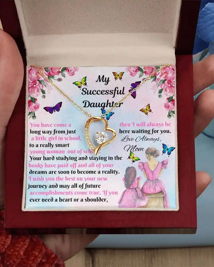 yellow gold forever love necklace in a mahogany box in model's hand