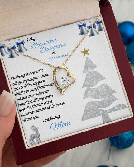 yellow gold forever love necklace in a luxury box in a model's hand