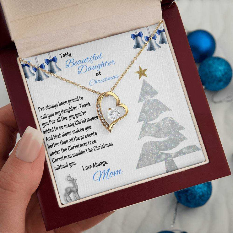 yellow gold forever love necklace in a luxury box in a model's hand