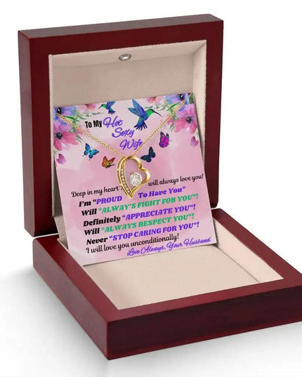 yellow gold forever love necklace in a mahogany box angled left