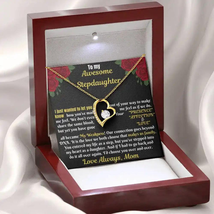 yellow gold forever love necklace in a mahogany box angled left